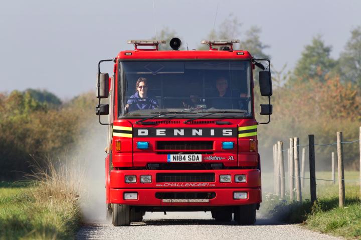 a truck driving down a dirt road