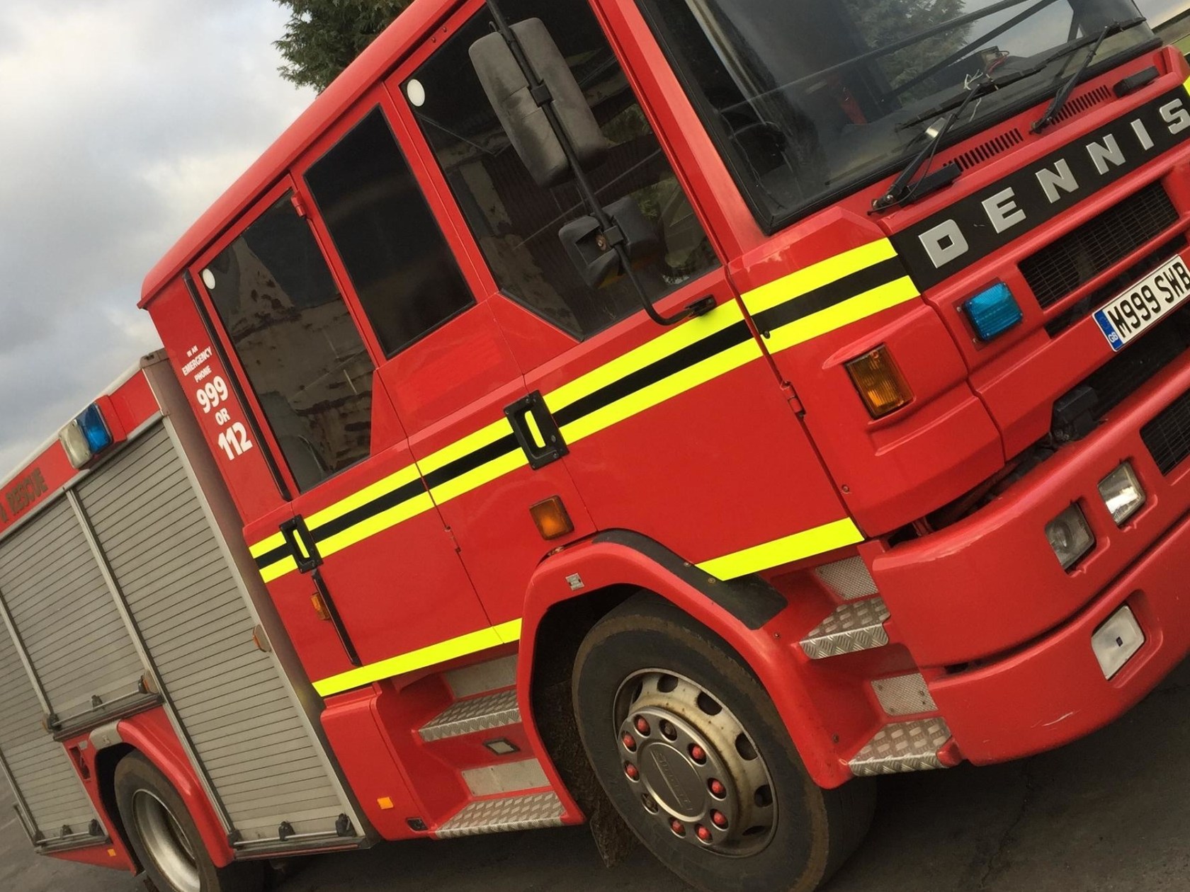 a yellow and red toy car on the back of a truck