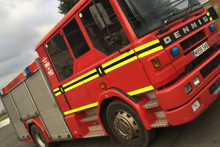 a yellow and red toy car on the back of a truck