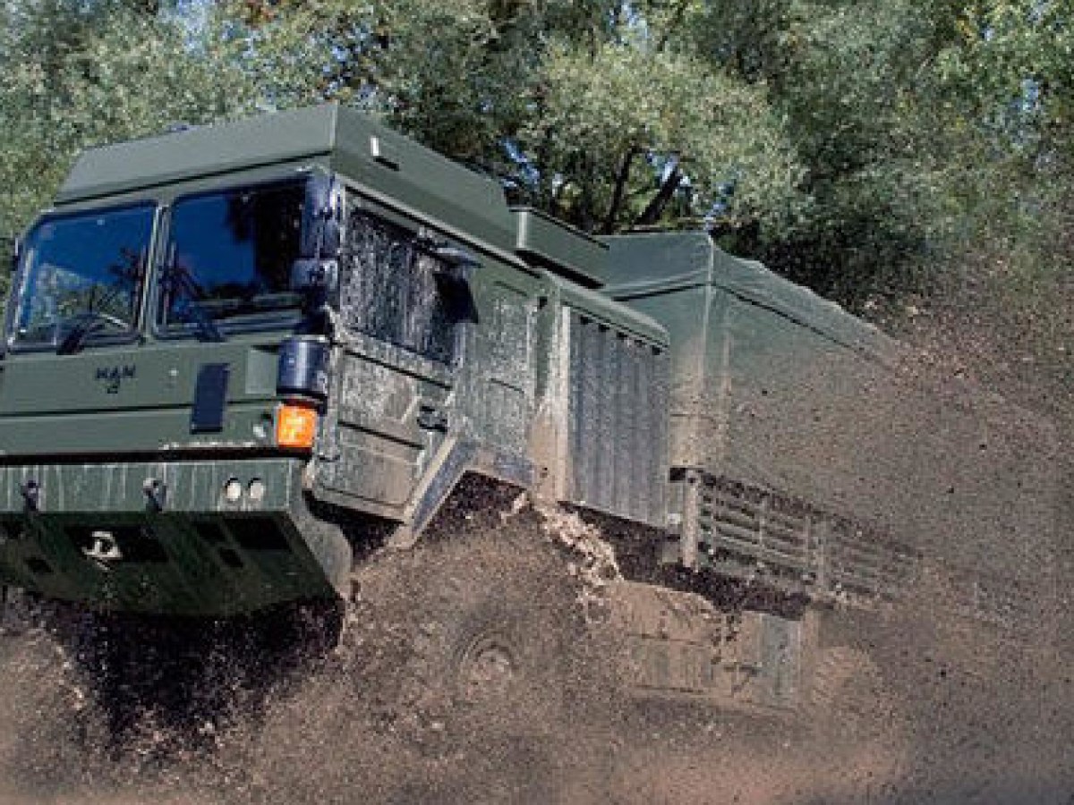 a truck driving down a dirt road