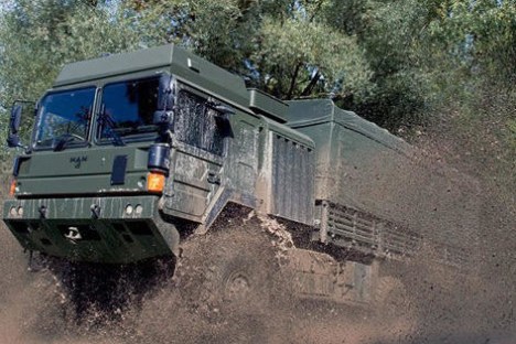 a truck driving down a dirt road