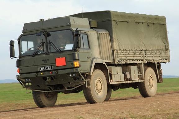 a large truck driving down a dirt road
