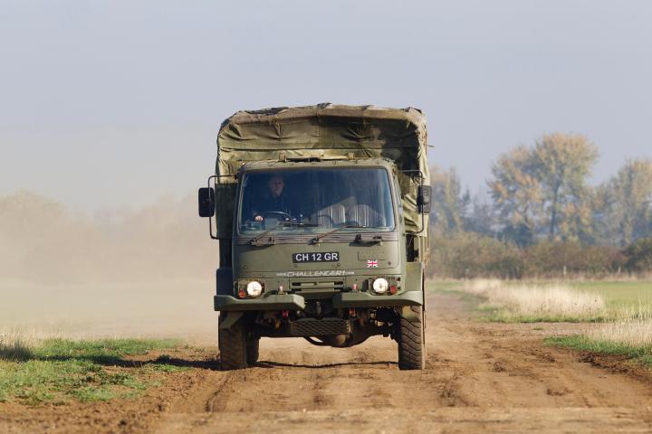 a truck driving down a dirt road