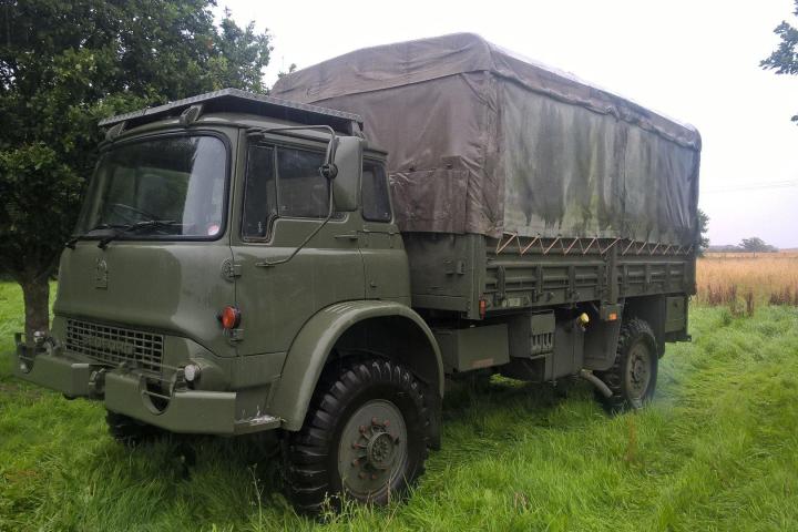a green truck parked in a field